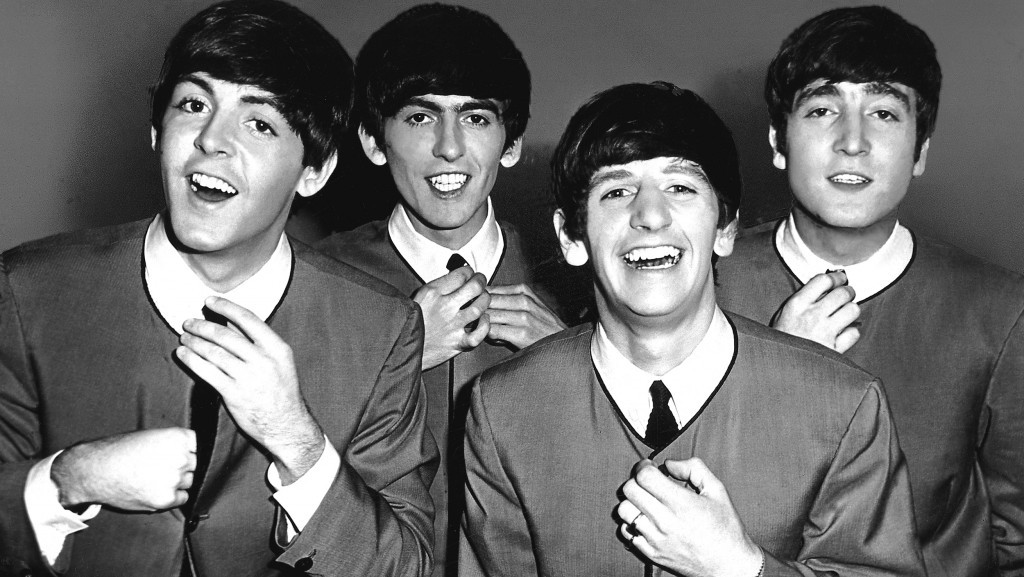 FILE - OCTOBER 5: 50 Years Since The First Beatles Single Released: A Look Back At The Beatles A group portrait of the Beatles, straightening their ties, backstage at the Odeon Cinema in Luton on 6th September 1963. (L-R) Paul McCartney, George Harrison, Ringo Starr, John Lennon. (Photo by Tom Hanley/Redferns)